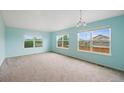 Bright living room features neutral carpet and large windows with views of the surrounding neighborhood at 4732 S Coolidge St, Aurora, CO 80016