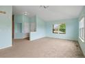 Spacious open-plan living area with carpeted floors and large windows, providing plenty of natural light at 4732 S Coolidge St, Aurora, CO 80016