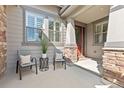 Inviting front porch featuring a seating area, perfect for enjoying the outdoors and welcoming guests at 15137 W 50Th Pl, Golden, CO 80403