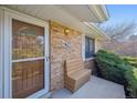 Front porch with a wooden bench for sitting at 19322 E Eldorado Dr, Aurora, CO 80013