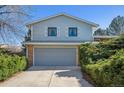 Two story home features lush landscaping, mature trees and a two car garage at 19322 E Eldorado Dr, Aurora, CO 80013