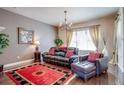 Relaxing living room featuring leather seating, a red rug, and large windows at 9129 Kornbrust Dr, Lone Tree, CO 80124