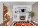 Living room with fireplace, built-in shelving, and hardwood floors at 9129 Kornbrust Dr, Lone Tree, CO 80124