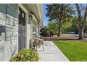Side view of inviting front porch with flowers and comfortable seating arrangement at 1431 S Glencoe St, Denver, CO 80222