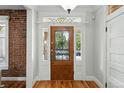 Elegant foyer featuring a beautiful front door with decorative glass and hardwood floors at 1582 Steele St, Denver, CO 80206