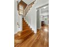 Elegant staircase with white railings and hardwood steps leading to the upper level at 1582 Steele St, Denver, CO 80206