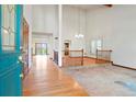 Bright foyer with hardwood floors and high ceilings, leading to other rooms at 15916 E Crestridge Pl, Centennial, CO 80015