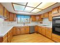 Traditional kitchen with wooden cabinets, white countertops, and stainless steel appliances at 15916 E Crestridge Pl, Centennial, CO 80015