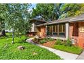 Inviting front entrance features lush landscaping, a brick facade, and a winding walkway at 255 Kiowa Pl, Boulder, CO 80303