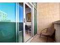 Cozy balcony featuring a chair and sliding glass door with a glimpse of an indoor workspace at 1700 Bassett St # 409, Denver, CO 80202