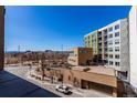 Scenic view from the balcony overlooking the neighborhood and distant mountains on a clear day at 1700 Bassett St # 409, Denver, CO 80202