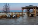 Inviting backyard patio with a covered gazebo and comfortable seating around a fire pit at 10883 E 163Rd Ct, Brighton, CO 80602