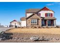 Charming two-story home with stone accents and a detached garage set on a manicured lot at 10883 E 163Rd Ct, Brighton, CO 80602