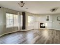 Sun-filled living room boasts a fireplace, large windows, and neutral paint tones at 21993 E Jamison Pl, Aurora, CO 80016