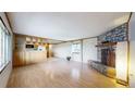 Bright living room with beautiful hardwood floors and a stone fireplace at 8509 Colorado Ct, Denver, CO 80229