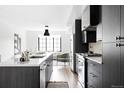 Modern kitchen with dark cabinetry, stainless steel appliances, and an island at 3408 W 17Th Ave, Denver, CO 80204