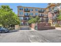 View of the building's secure parking garage with brick and concrete elements and greenery around it at 10184 Park Meadows Dr # 1317, Lone Tree, CO 80124