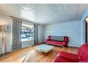 Living room with hardwood floors and red couches at 7625 W 23Rd Pl, Lakewood, CO 80214