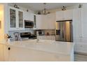 Bright kitchen featuring quartz countertops, stainless steel appliances, and ample cabinet space at 8500 E Jefferson Ave, Denver, CO 80237