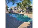 Community pool area with lounge chairs, tables, and umbrellas for residents at 8500 E Jefferson Ave, Denver, CO 80237