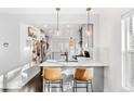 Modern kitchen bar seating with quartz countertops and stylish pendant lighting at 4270 Irving St, Denver, CO 80211