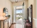 Inviting entryway featuring wood floors, a decorative cabinet and mirror, and a coat rack at 16550 Antero Cir, Broomfield, CO 80023