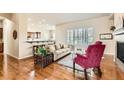 Open living area with hardwood floors, large windows with shutters, and a cozy seating area at 16550 Antero Cir, Broomfield, CO 80023