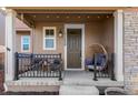 Inviting front porch adorned with a relaxing swing chair and comfortable seating, perfect for outdoor enjoyment at 11420 E 26Th Ave, Aurora, CO 80010