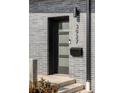 Modern front door, featuring a sleek design, house numbers, and a black mailbox at 3927 N Cook St, Denver, CO 80205
