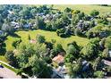 Overhead view of the home in a lush, green neighborhood with mature trees and open space at 6396 Twin Lakes Rd, Boulder, CO 80301