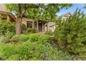 Charming home with lush landscaping leading up to the inviting front porch and secure front door at 2253 N Williams St, Denver, CO 80205
