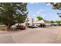 Community parking area with covered parking spots and mature trees at Lake Arbor Village at 8126 Gray Ct # 499, Arvada, CO 80003