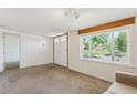 Bright living room with large window and double doors providing ample natural light at 1175 Xanthia, Denver, CO 80220