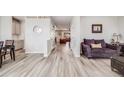 Bright living room featuring wood-look floors, stylish furniture, and a welcoming atmosphere at 7961 E 131St Ave, Thornton, CO 80602