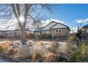 Brick ranch house with a landscaped yard and mature tree at 3075 Elm St, Denver, CO 80207