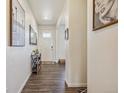 Inviting entryway with wood-look floors and stylish decor at 803 William Way, Brighton, CO 80603