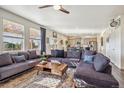 Open living room with sectional sofa and kitchen view at 803 William Way, Brighton, CO 80603