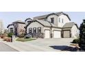 A beautiful stucco and stone home with a three-car garage and a large driveway is featured at 16791 W 48Th Ln, Golden, CO 80403