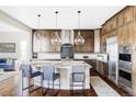 Spacious kitchen featuring a large island, stainless steel appliances, and stylish pendant lighting at 16791 W 48Th Ln, Golden, CO 80403