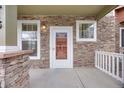 Inviting front porch features stone accents and a white door with glass at 22813 E Briarwood Pl, Aurora, CO 80016