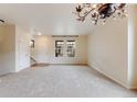 Large living room with neutral walls, carpet, and staircase access to upper level at 22813 E Briarwood Pl, Aurora, CO 80016