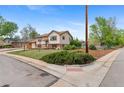 Charming two-story home with a well-manicured lawn and mature trees on a corner lot at 1549 Dean Dr, Northglenn, CO 80233
