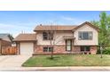 Charming two-story home with brick and siding exterior, a well-maintained front yard and attached garage at 1549 Dean Dr, Northglenn, CO 80233