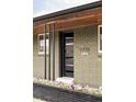 Modern front door with glass panes, enhancing the curb appeal of this home at 1330 Olive St, Denver, CO 80220