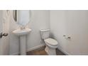 Neat half bath with a pedestal sink and modern fixtures at 24790 E 39Th Ave, Aurora, CO 80019