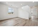 Bright, open-concept living area with sleek hardwood floors and ample natural light at 24790 E 39Th Ave, Aurora, CO 80019