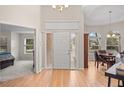 Bright foyer with hardwood floors, arched windows, and a view into the dining area at 1011 S Valentia St # 3, Denver, CO 80247