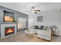Comfortable living room with fireplace, ceiling fan, and neutral decor at 9080 Gale Blvd # 4, Thornton, CO 80260