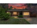 Cozy brick home at sunset with a beautiful lawn and mature landscaping, creating a warm and inviting atmosphere at 3031 W 20Th Ave, Denver, CO 80211