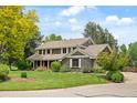 Beautiful two-story home with manicured lawn, mature trees and a tranquil suburban setting at 6128 S Coventry E Ln, Littleton, CO 80123